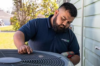 Baytown HVAC technician inspecting air conditioning unit