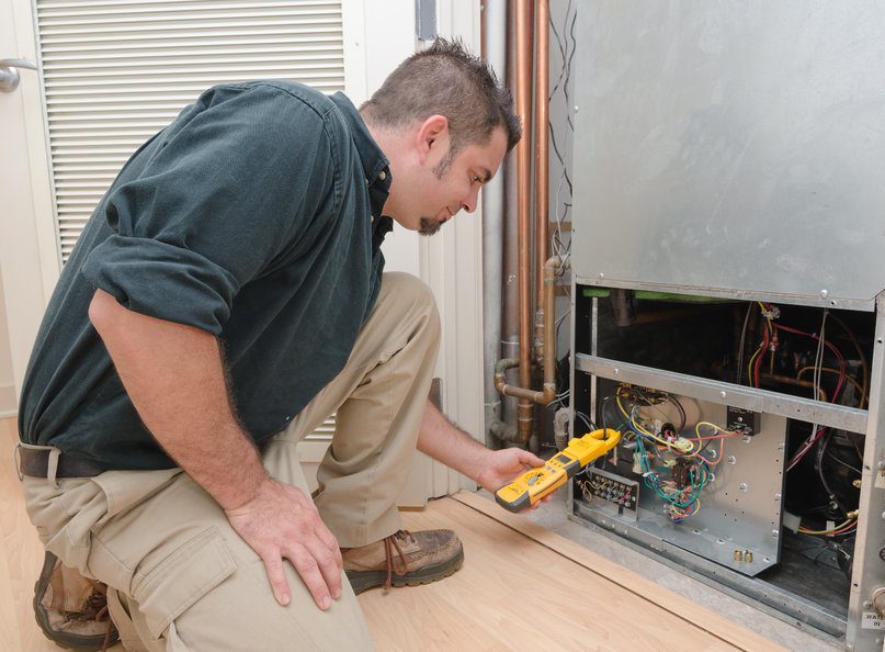 hvac tech performing heating maintenance